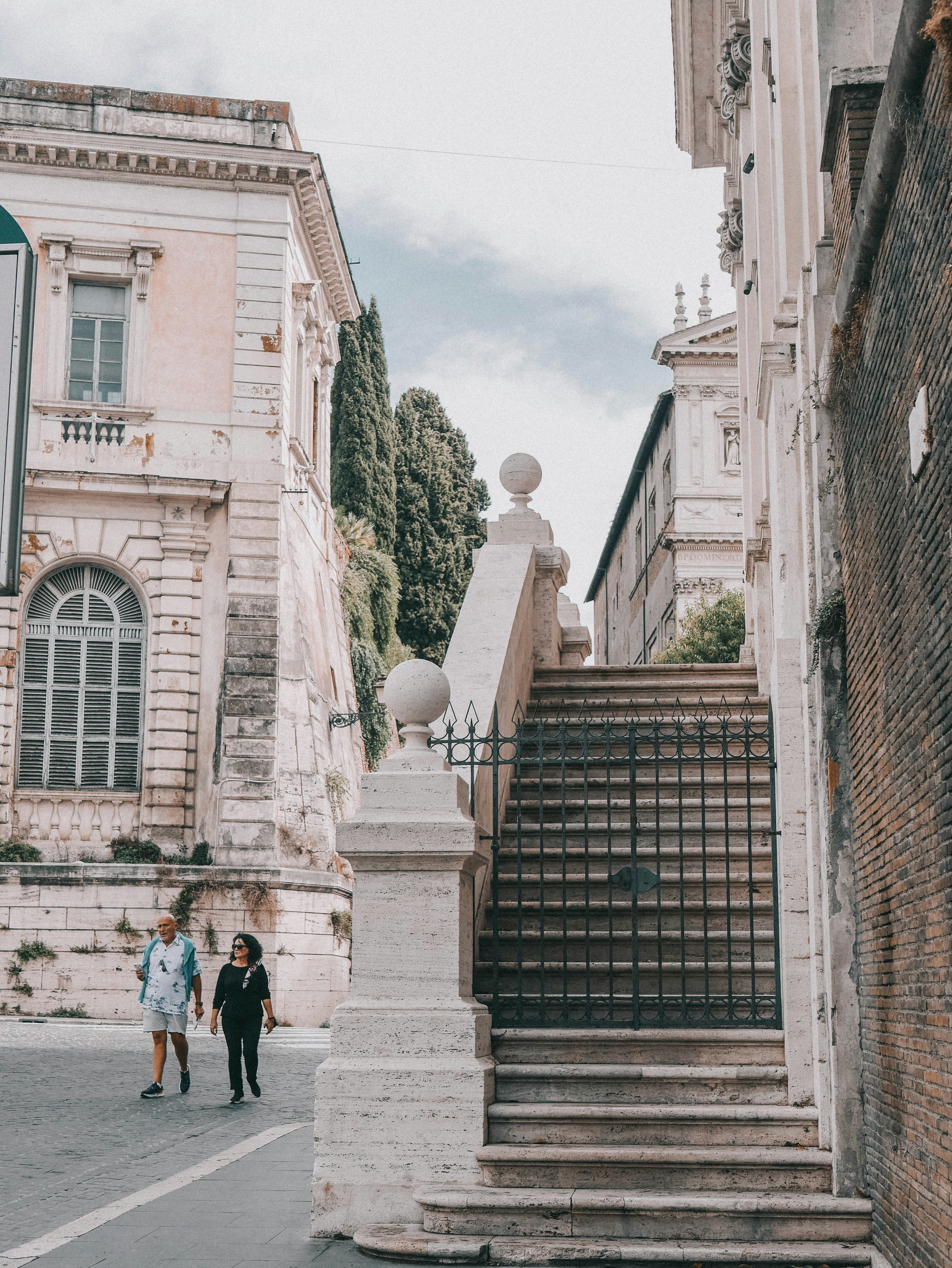 a couple of people that are walking down a street