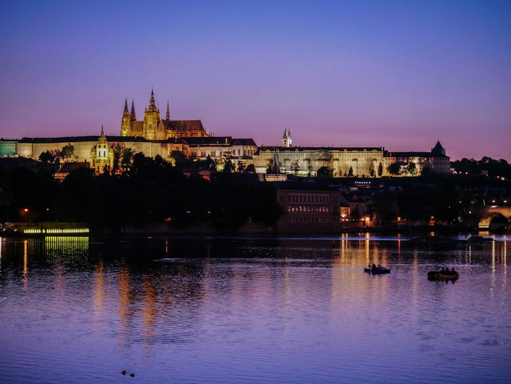 a large castle sitting on top of a hill next to a body of water