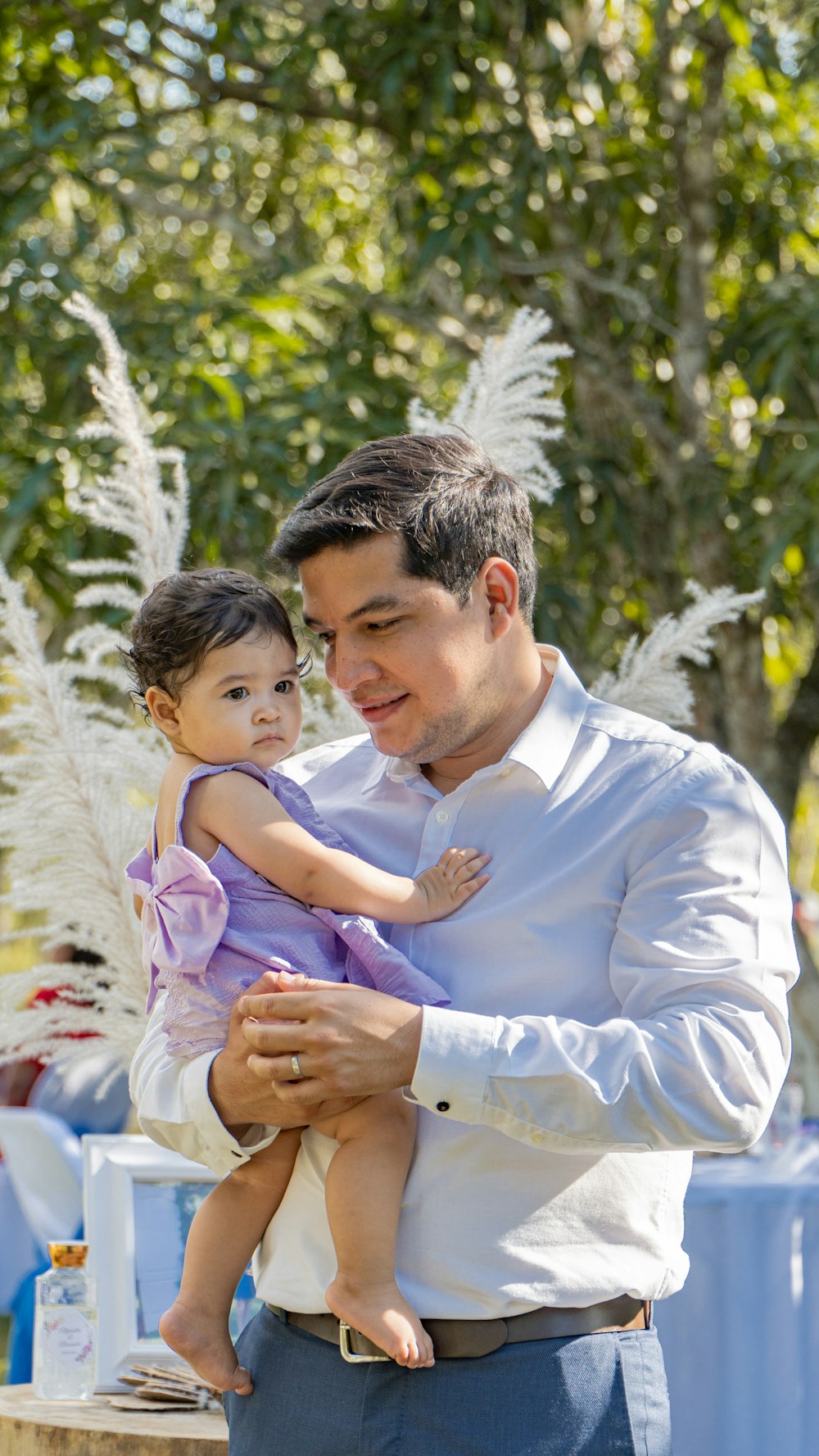 a man holding a little girl in his arms