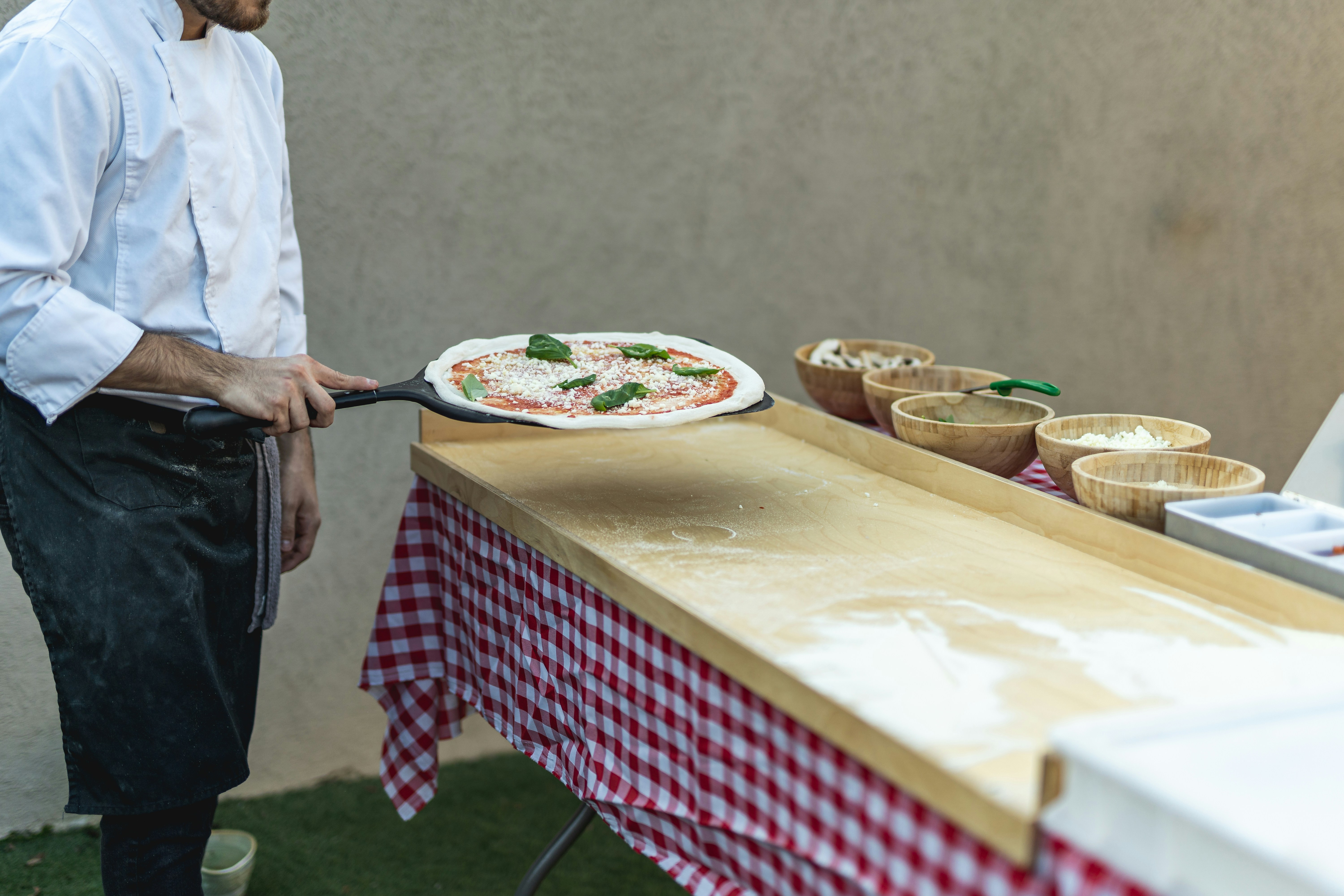 Man standing in front of a table with a pizza