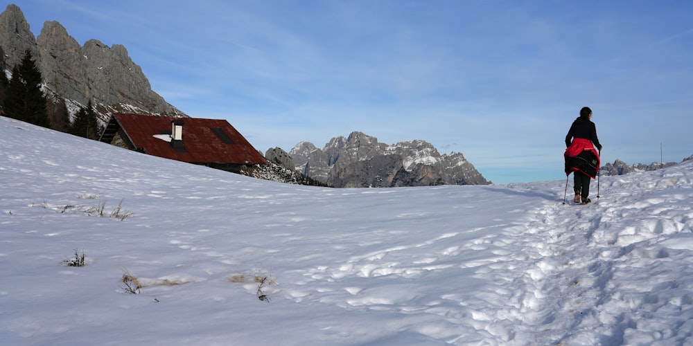 a person walking in the snow with skis on