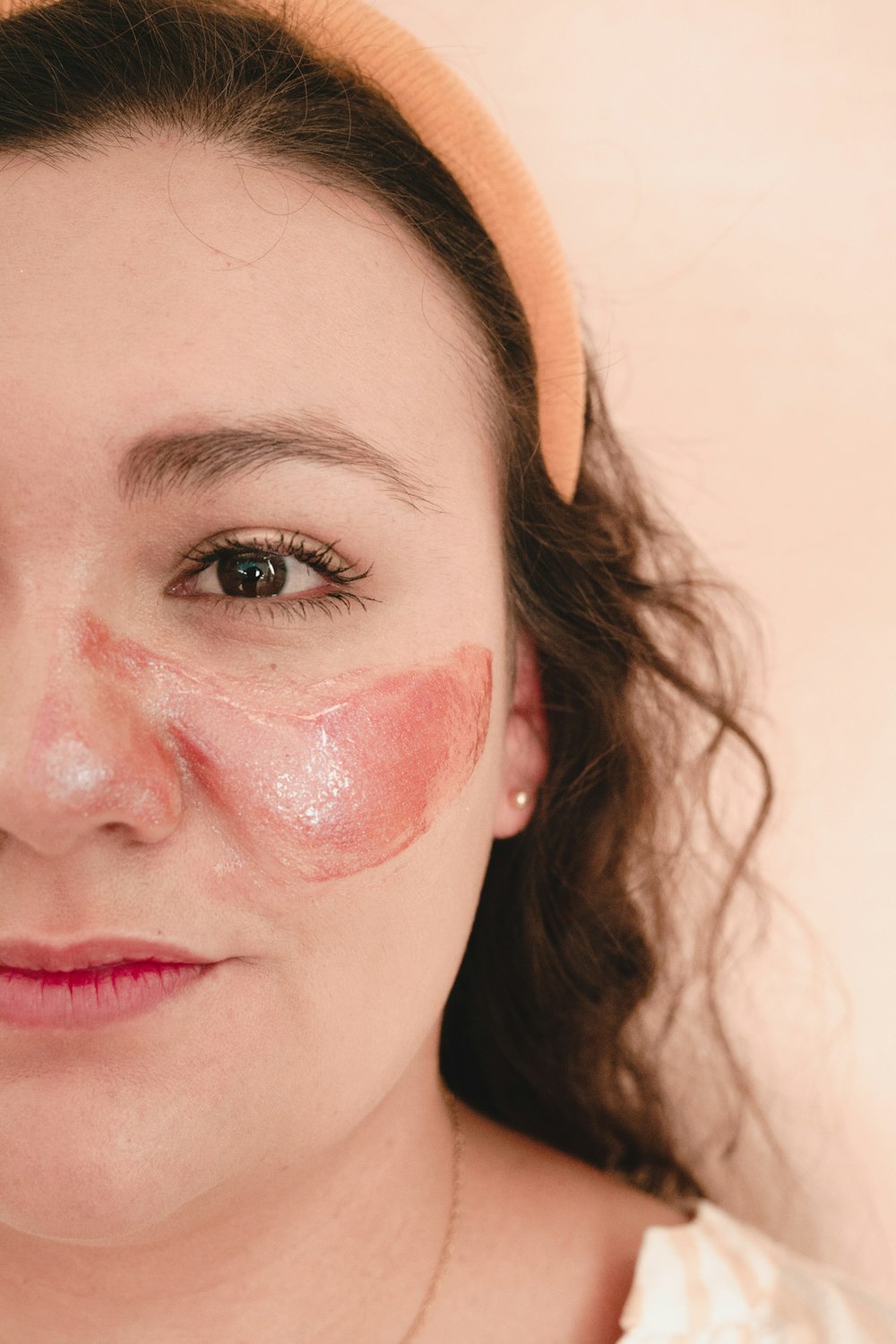 a woman with a pink patch on her face