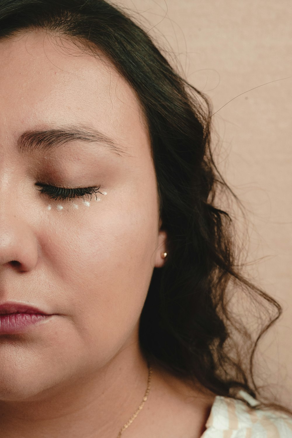 a close up of a woman with her eyes closed