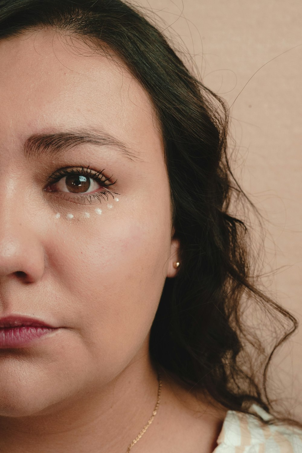 a close up of a person wearing a necklace