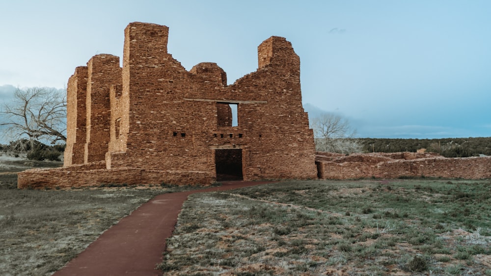 a large brick building sitting on top of a grass covered field