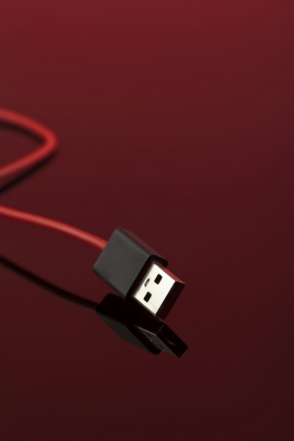 a red cord connected to a black device