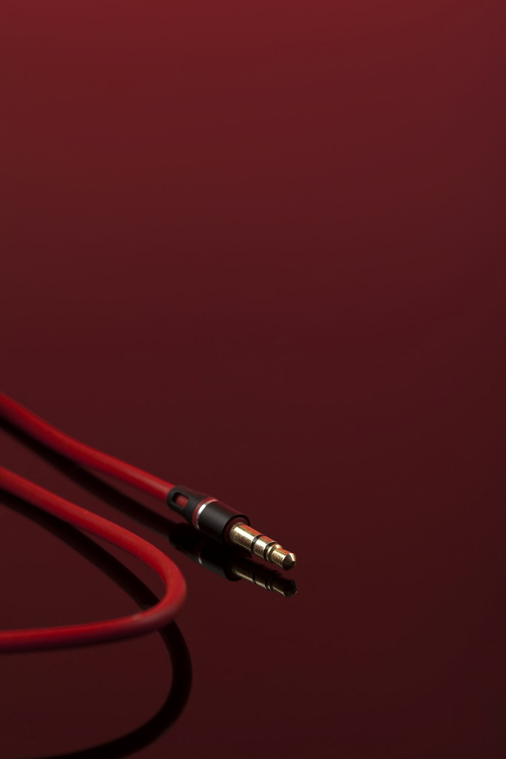 a close up of a pair of ear buds on a red background