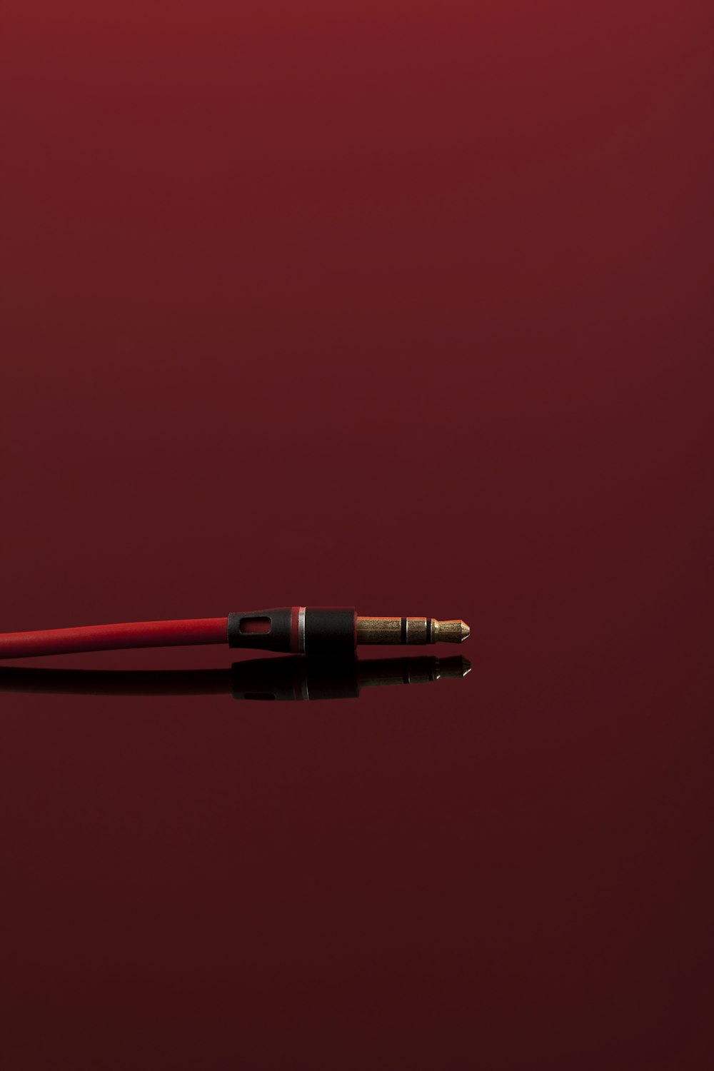 a red pen with a black tip on a red background