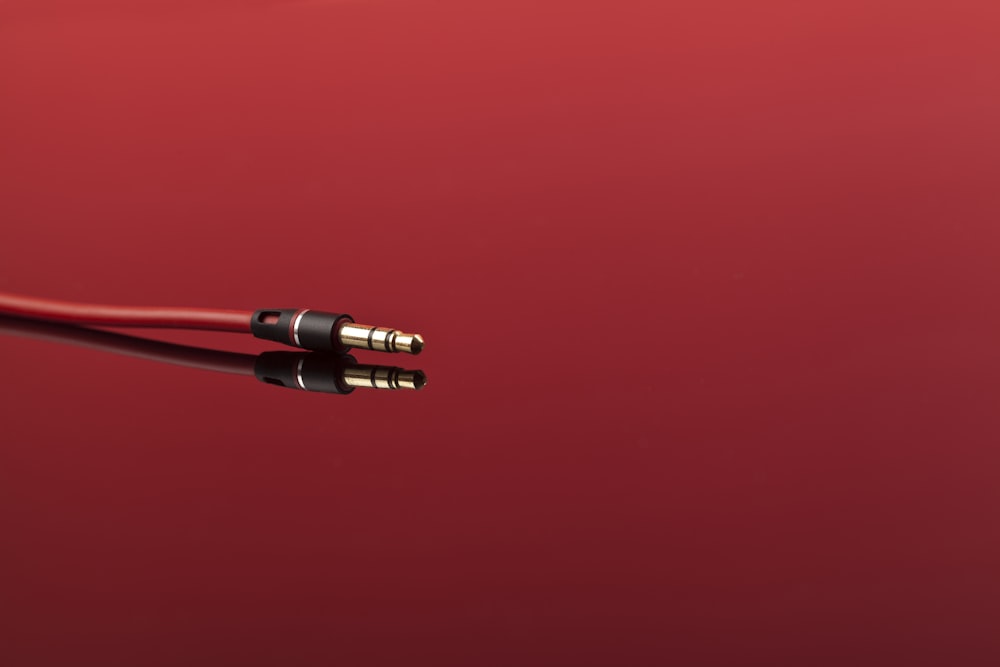 a close up of a red and black cable