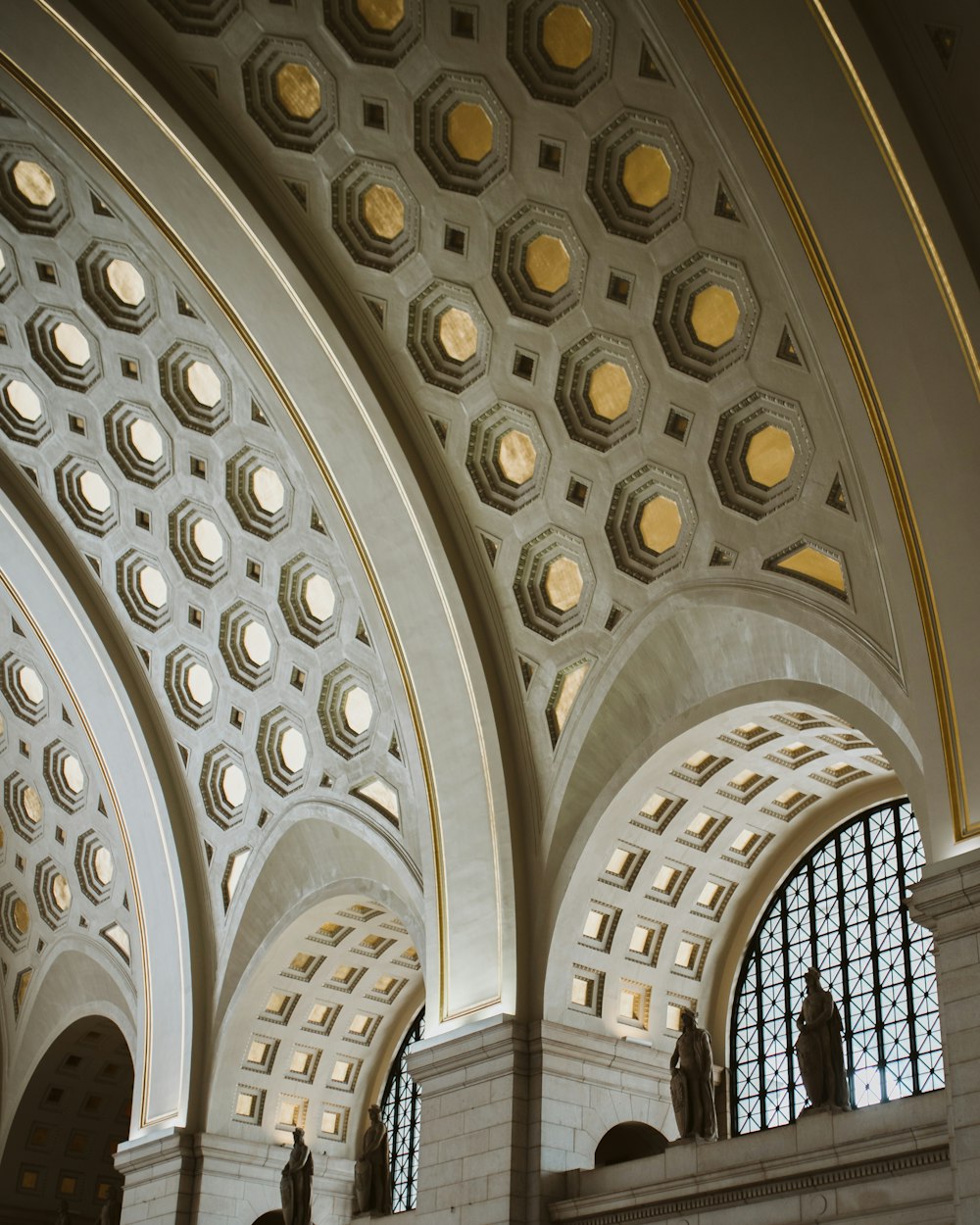 the ceiling of a large building with many windows