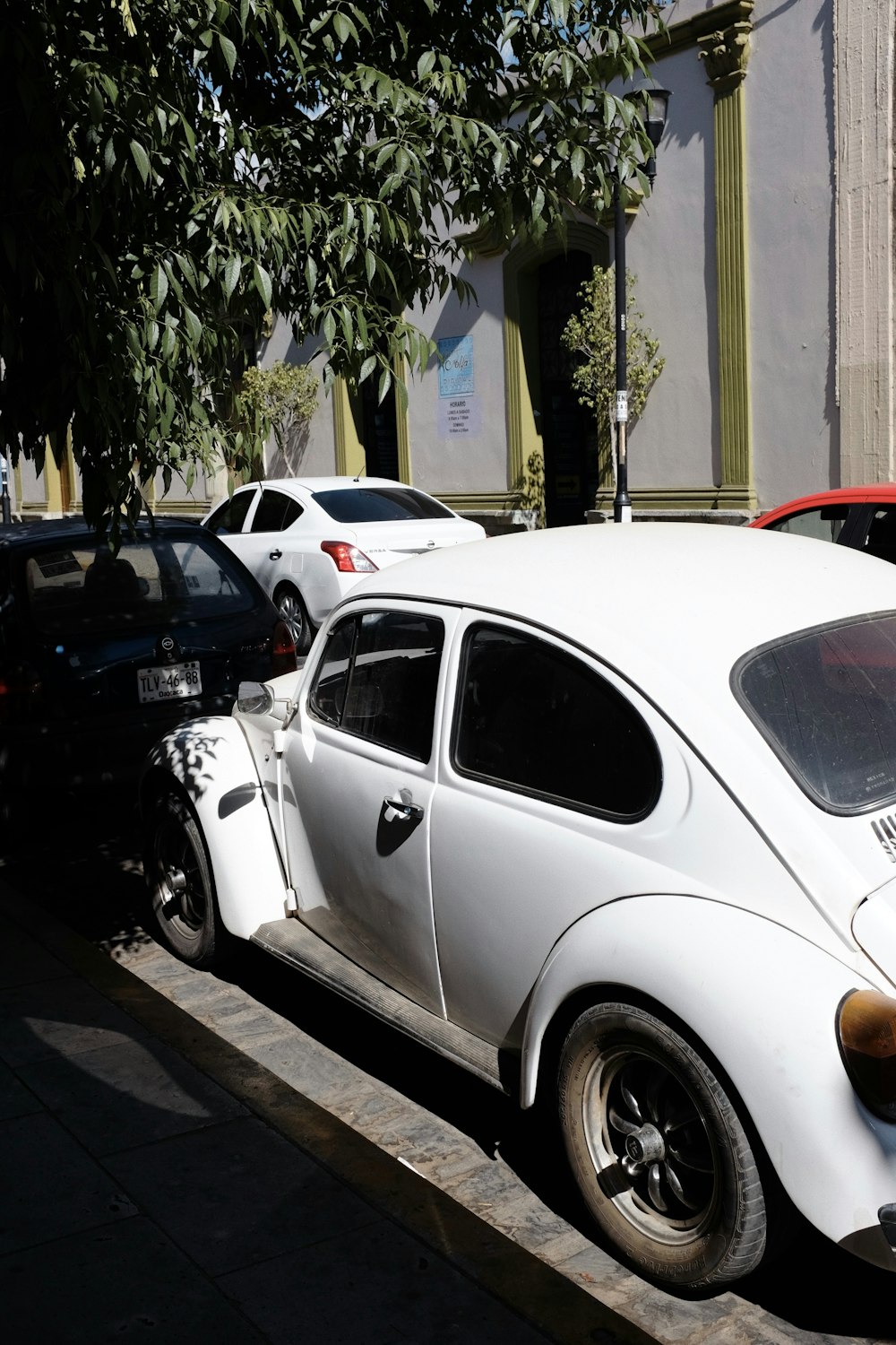 a white car parked on the side of a street