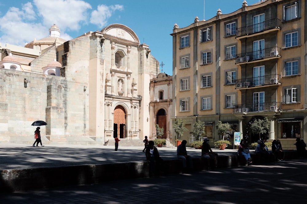 a group of people sitting on steps in front of a building