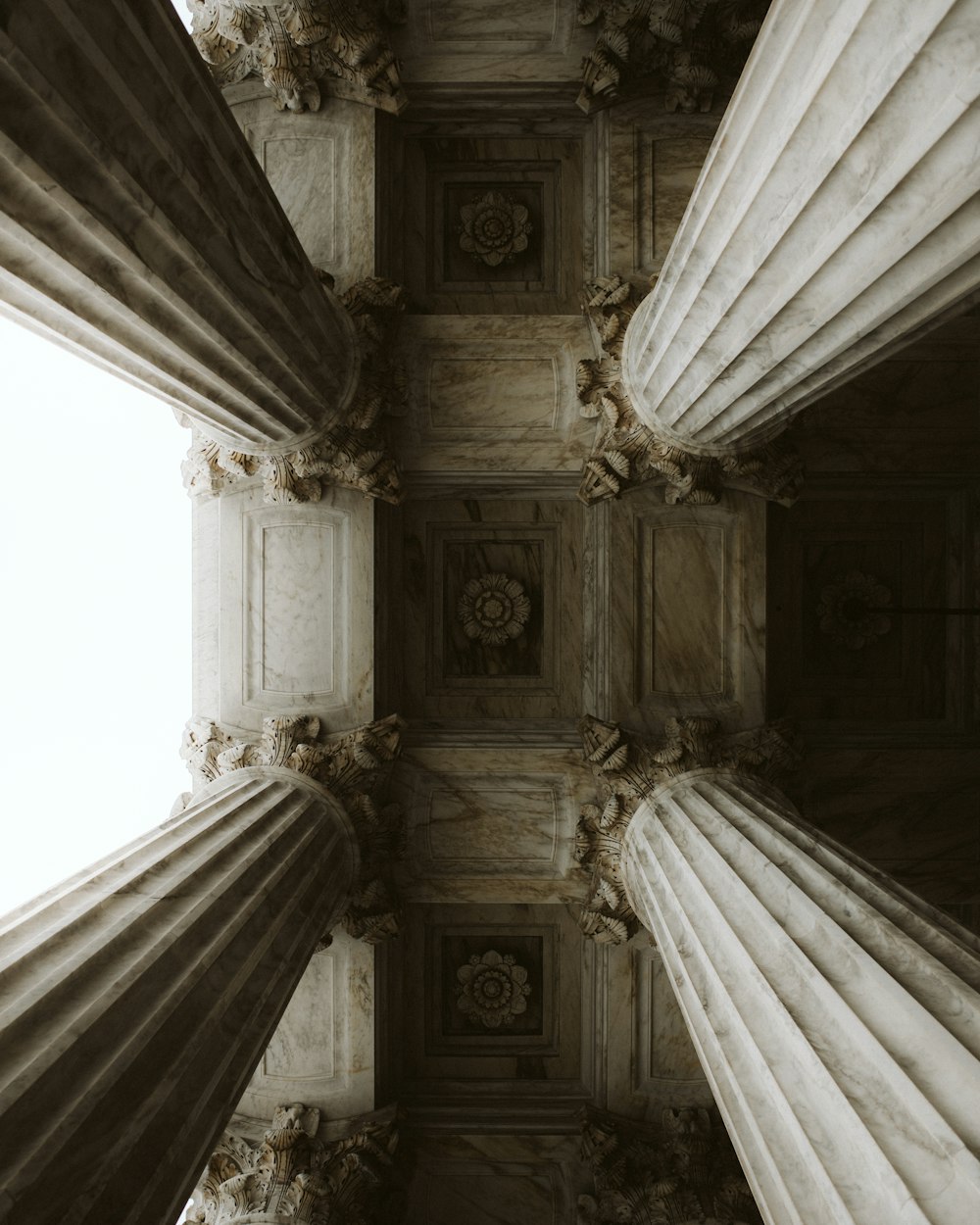 a view of the ceiling of a building with columns