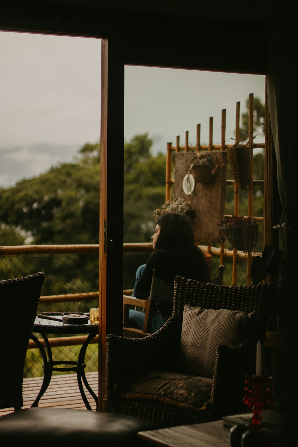 a woman sitting in a chair looking out a window