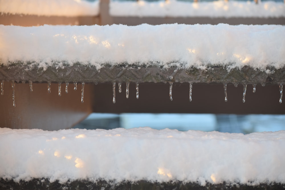 icicles are hanging from the roof of a building