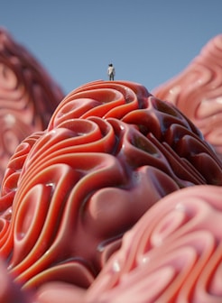 a person standing on top of a giant pink object