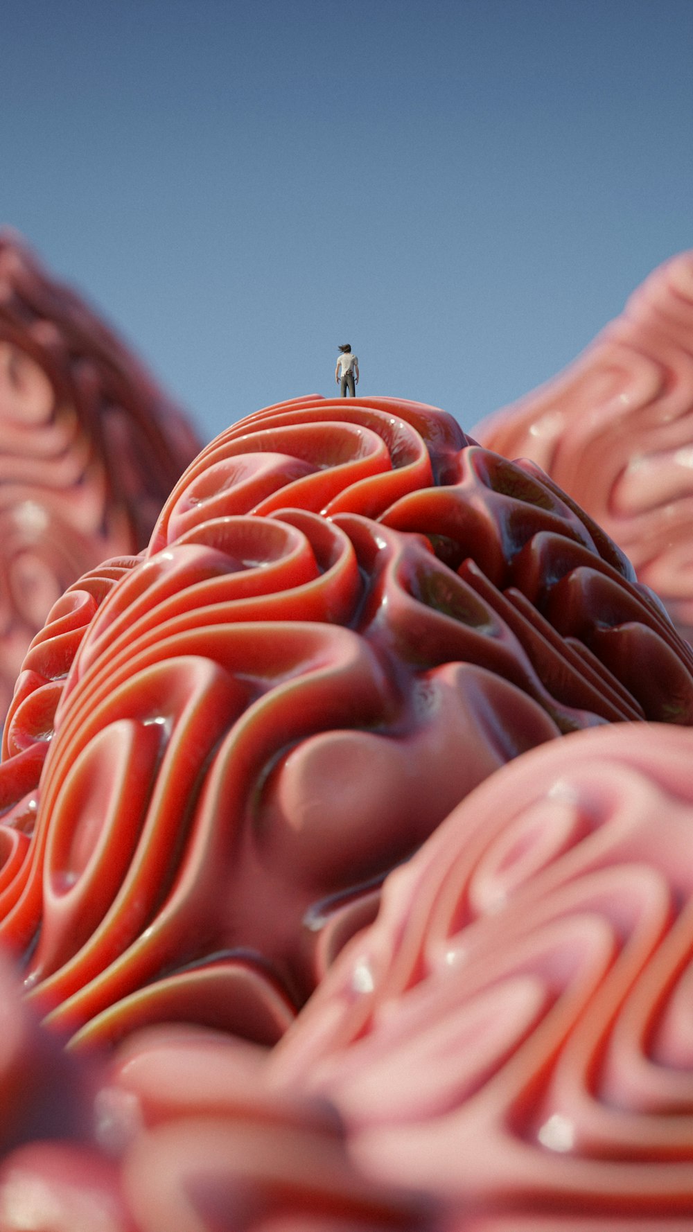 a person standing on top of a giant pink object