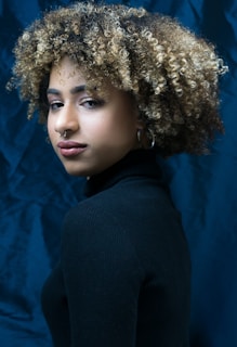 a close up of a person with a curly hair