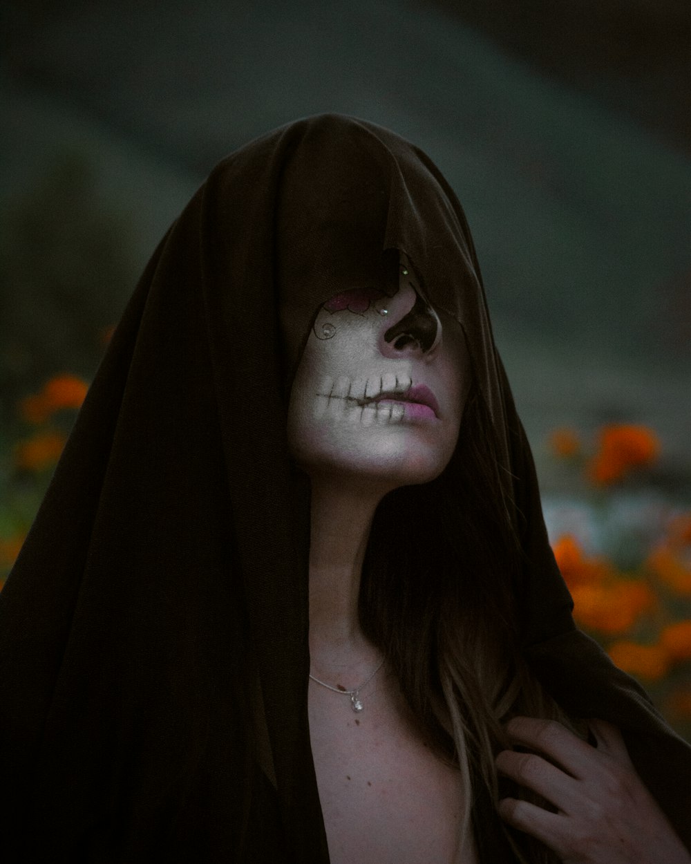 a woman with a skeleton face painted on her face