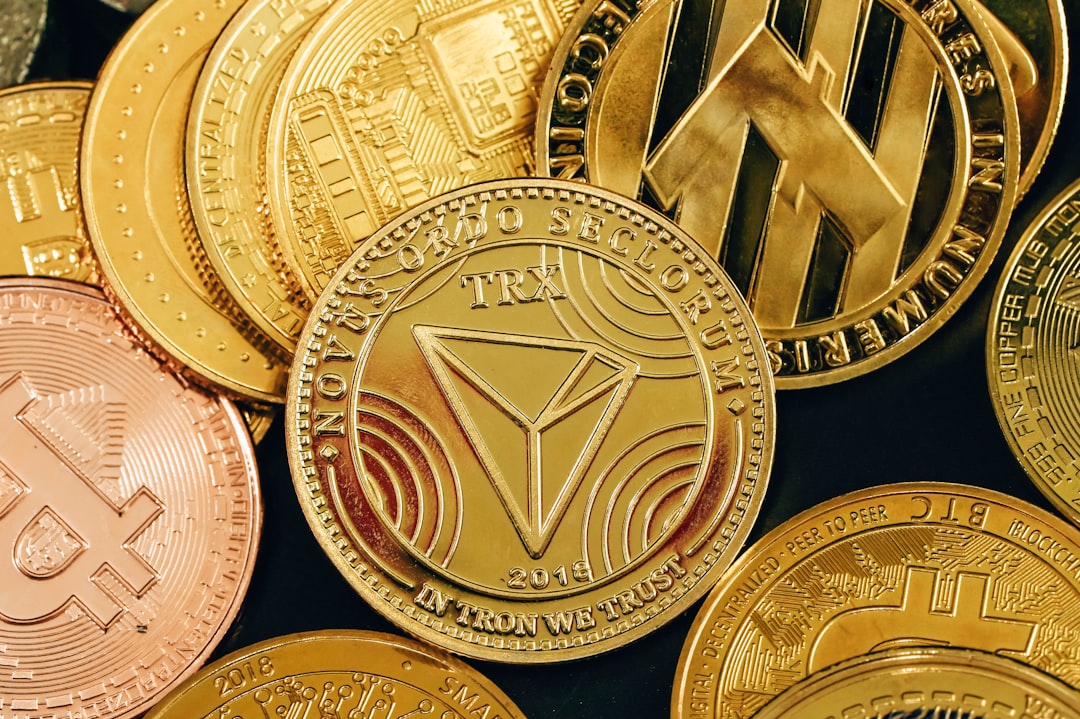 a pile of gold and silver bitcoins, A pile of cryptocurrency coins placed on a black surface