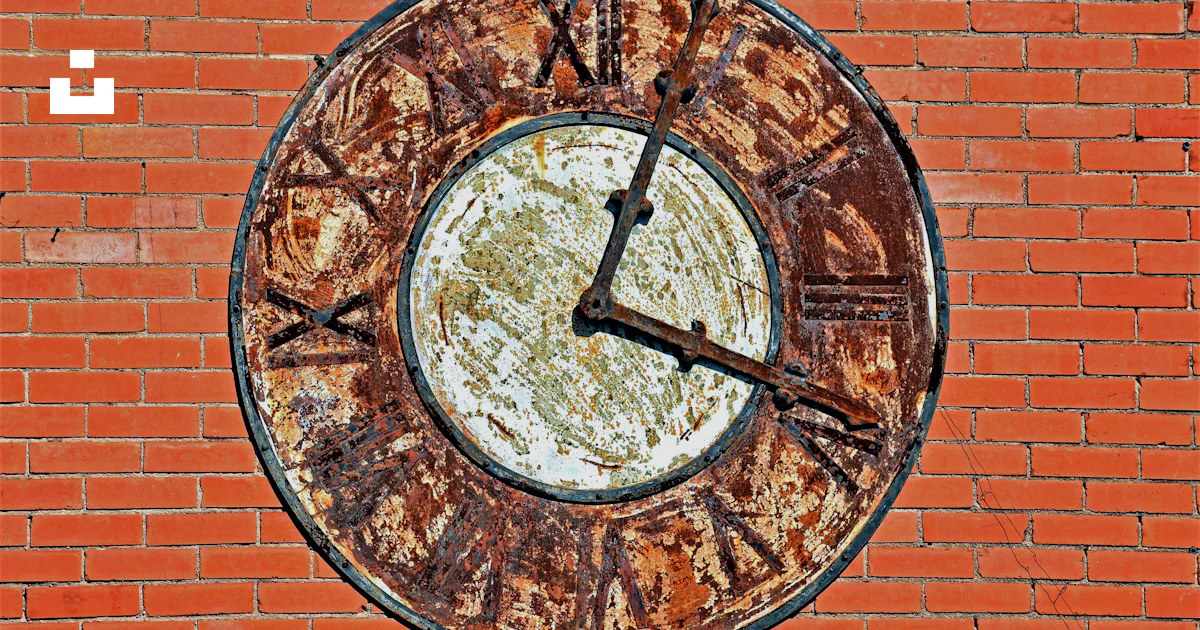 Busted Rusted Clock A rusted clock on a brick wall photo – Free Clock Image on Unsplash