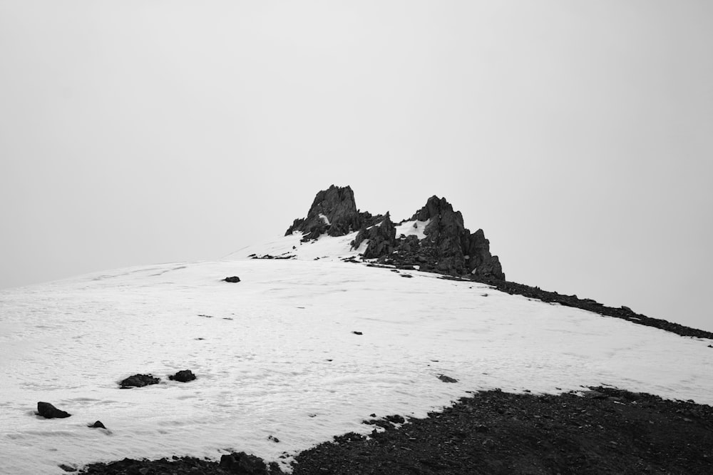 a black and white photo of a snow covered mountain