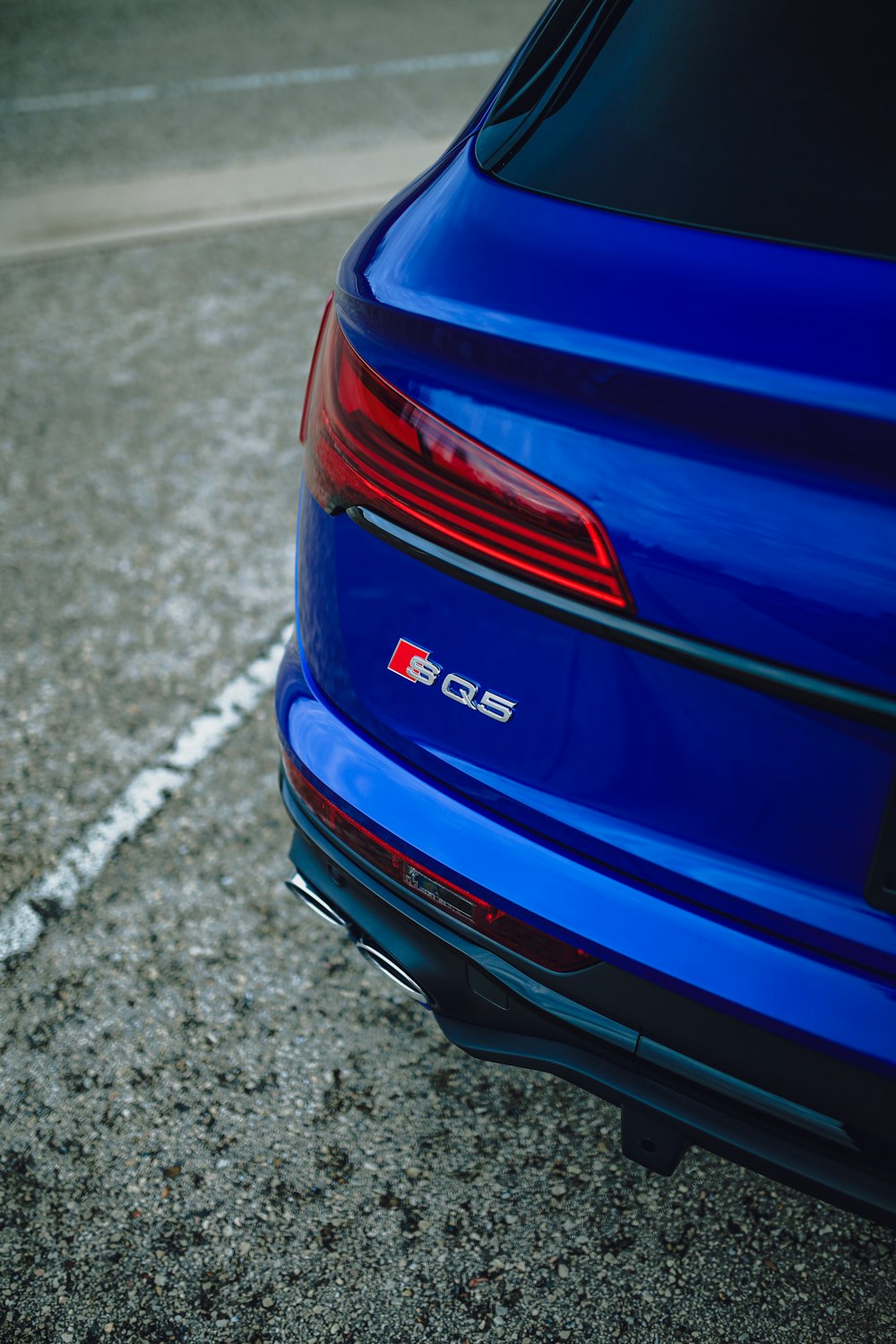 a close up of the tail end of a blue car