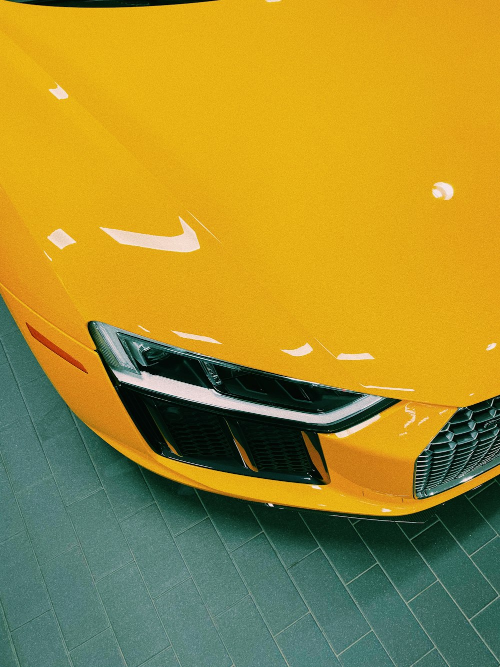 a yellow sports car parked in a garage