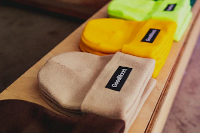 a row of socks sitting on top of a wooden shelf