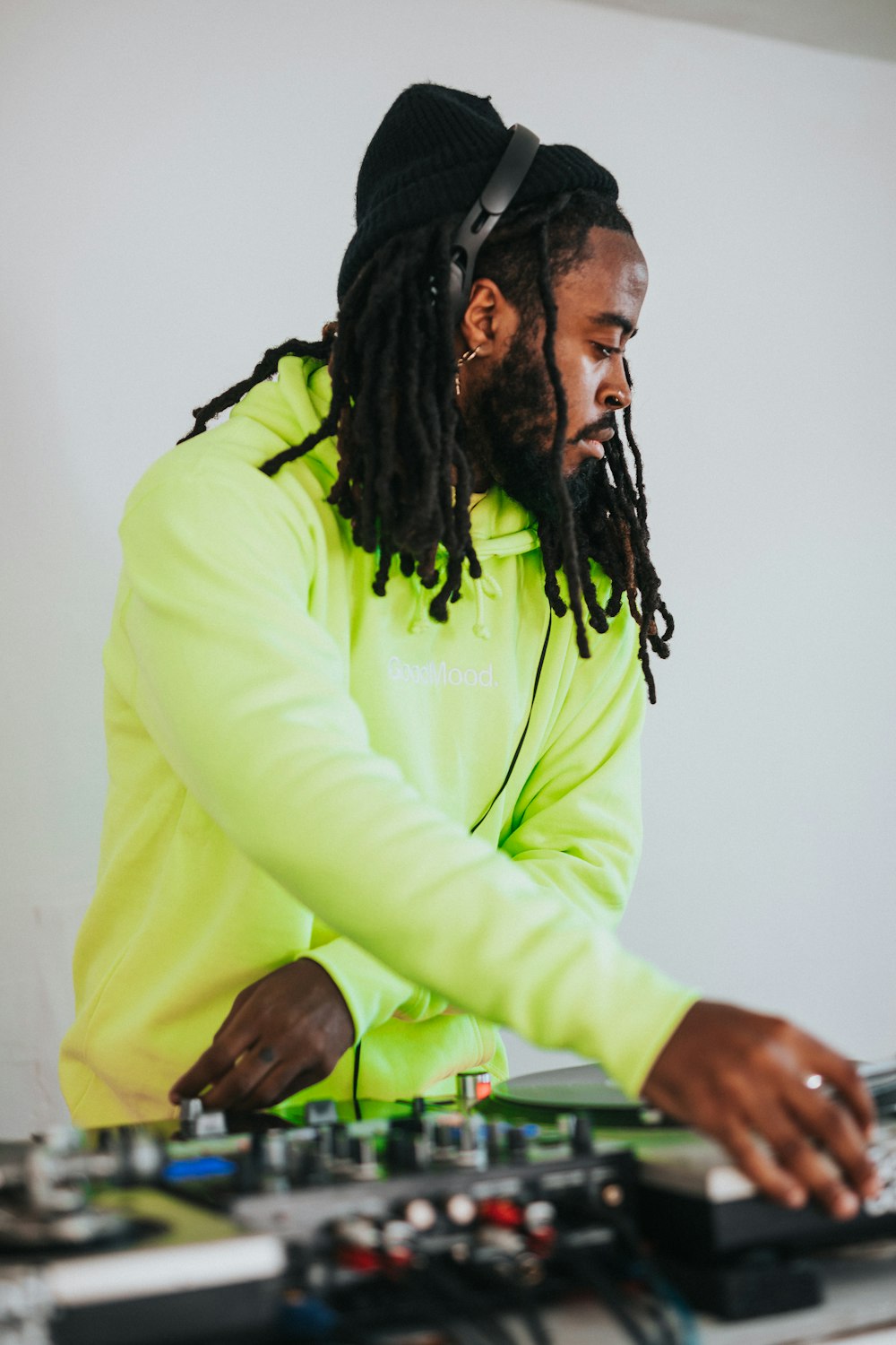 a man with dreadlocks playing a dj set