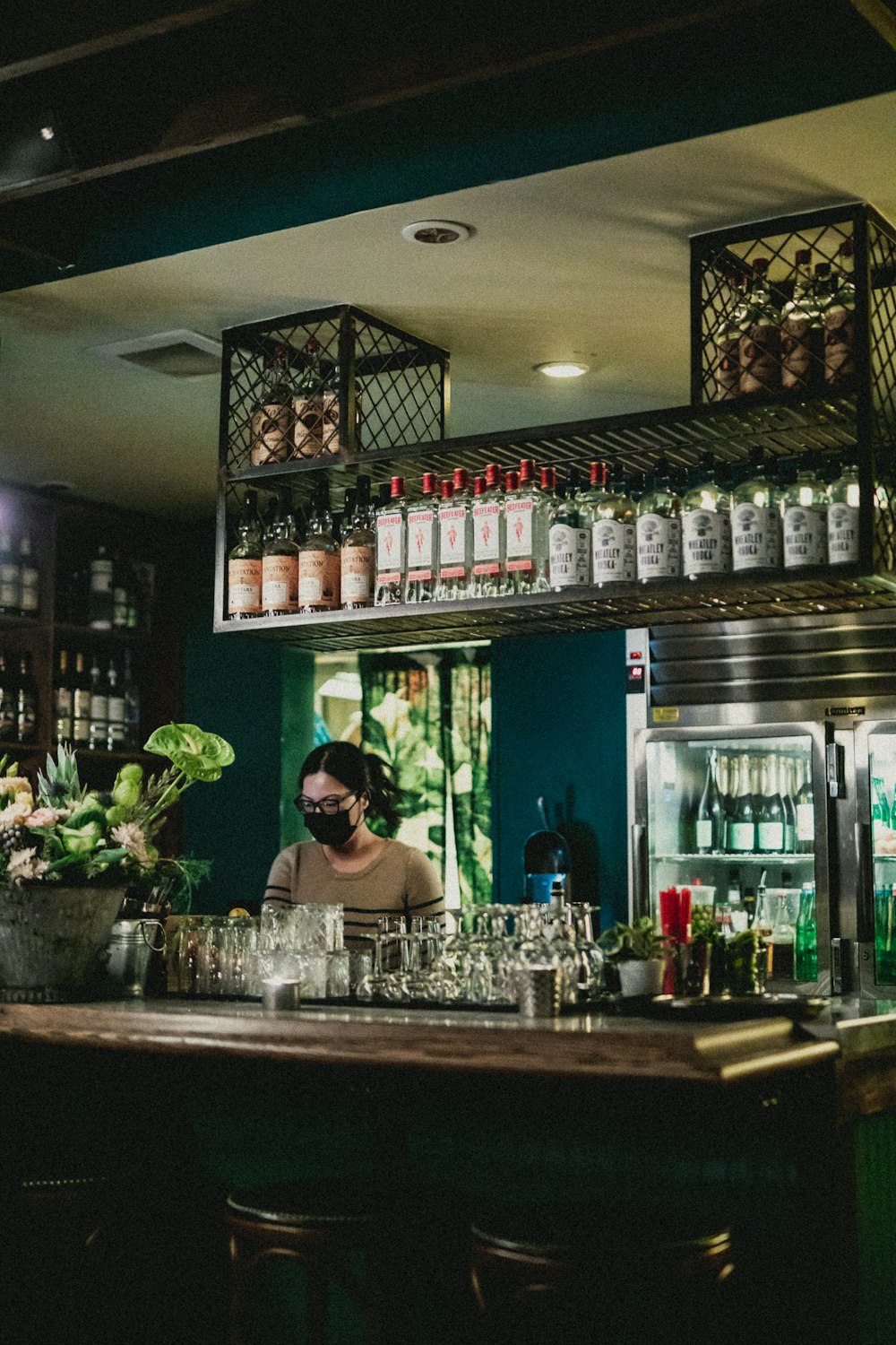 a woman behind the bar of a restaurant