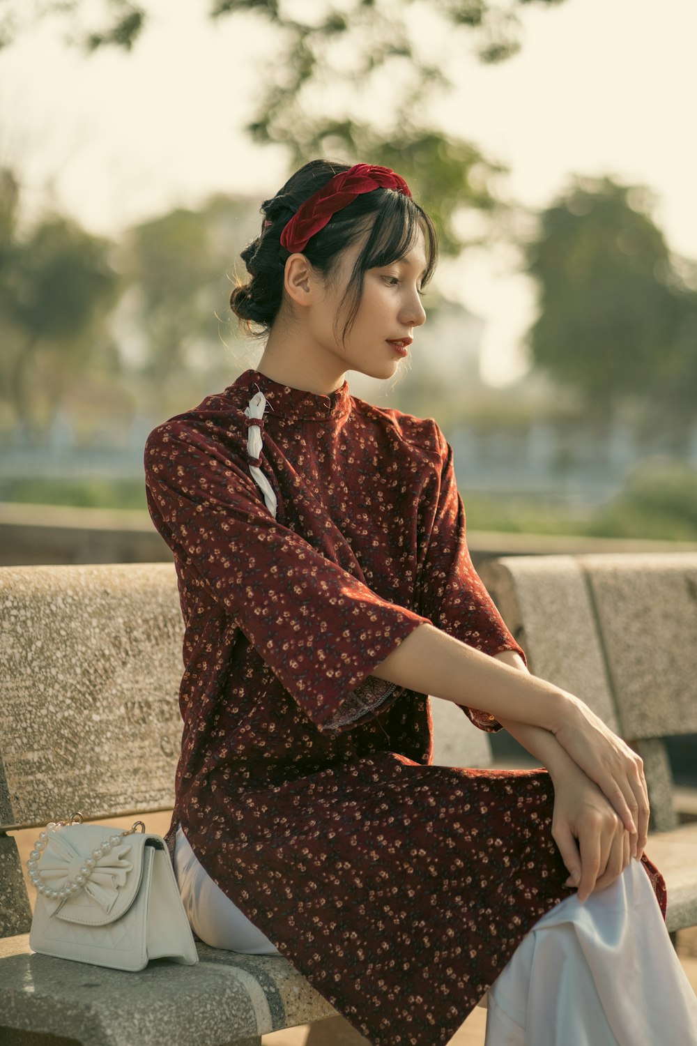 a woman sitting on top of a wooden bench