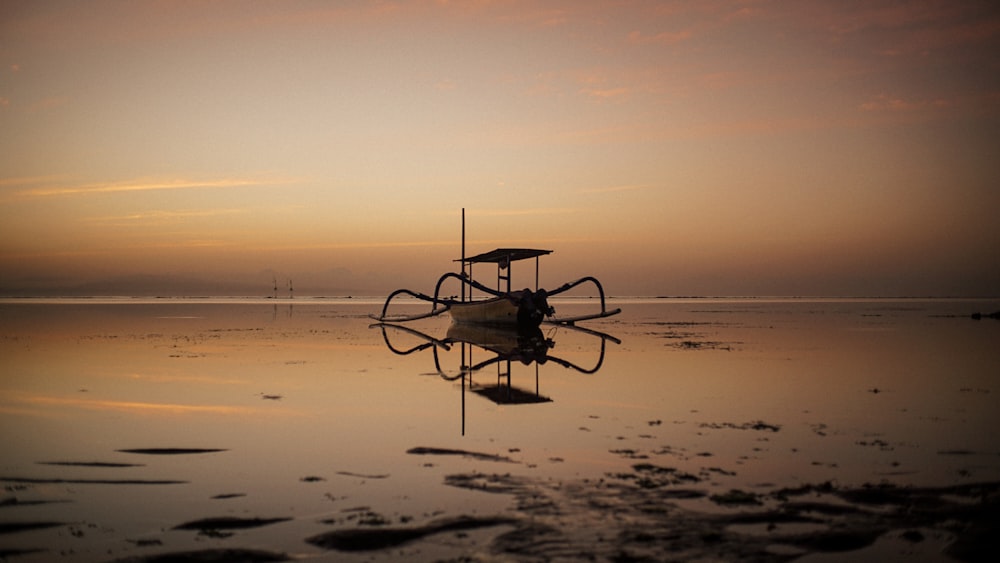 a boat sitting on top of a body of water