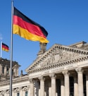 a german flag flying in front of a building