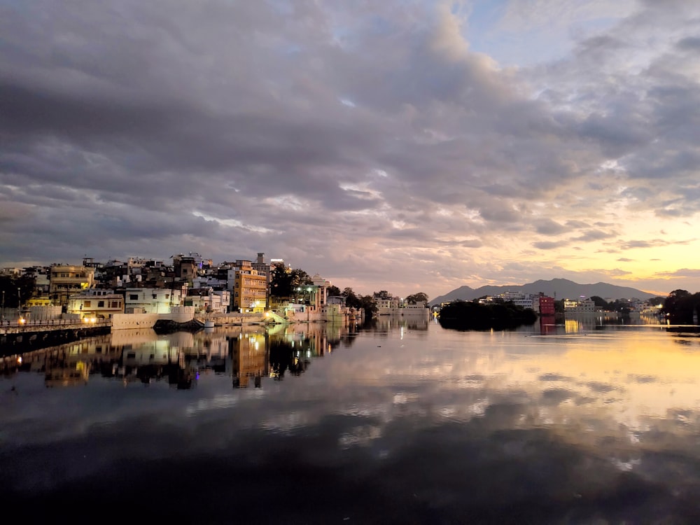 a body of water with a city in the background