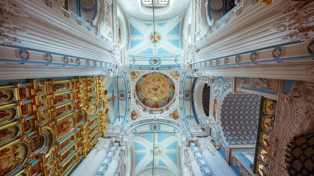 the ceiling of a church with a clock on it