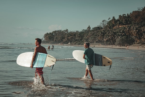 Two surfers enter the water in Costa Rica