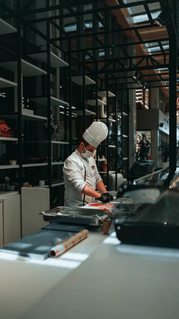 A cook preparing food in the kitchen