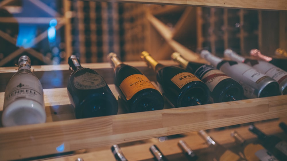 several bottles of wine are lined up on a shelf