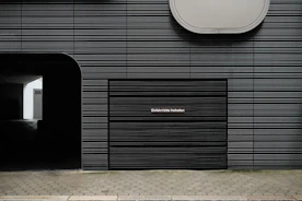 a black building with a clock on the side of it