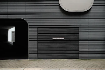 a black building with a clock on the side of it