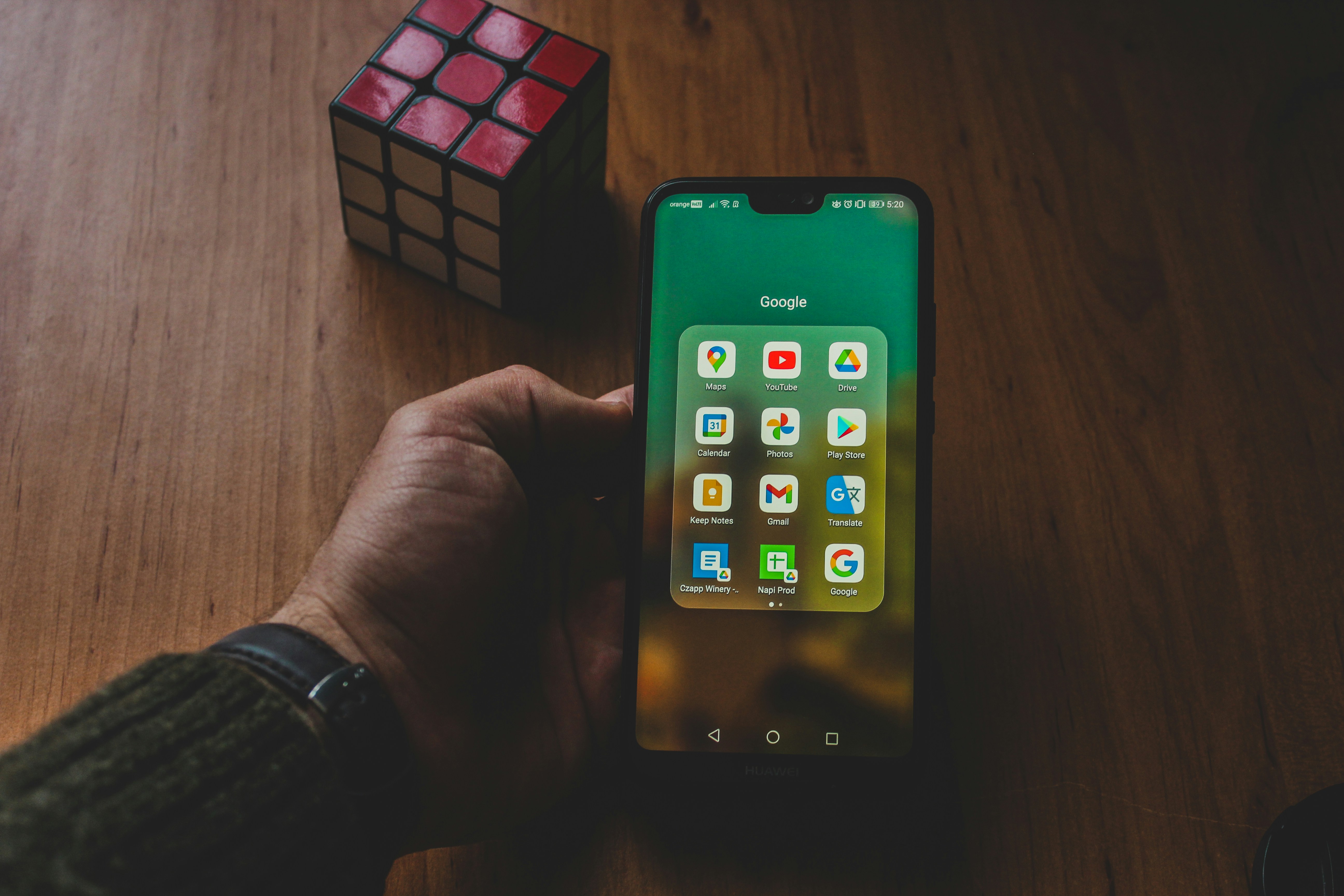 hands holding clean smartphone showing minimalist logic puzzle game grid