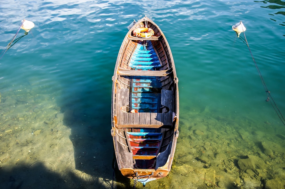 a small boat floating on top of a body of water