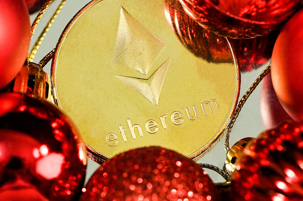 a close up of a red and gold christmas ornament