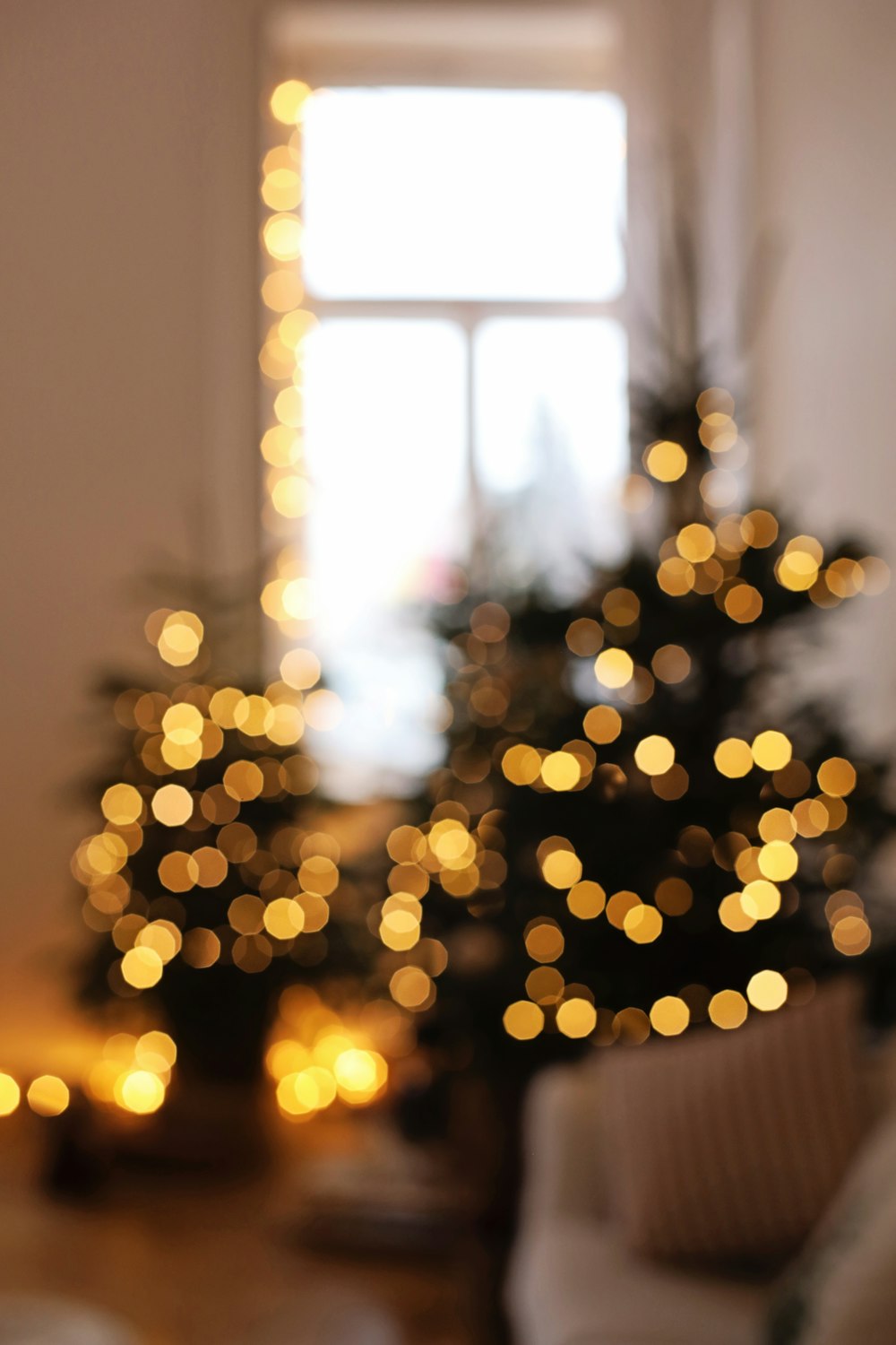 a living room with a christmas tree in the background