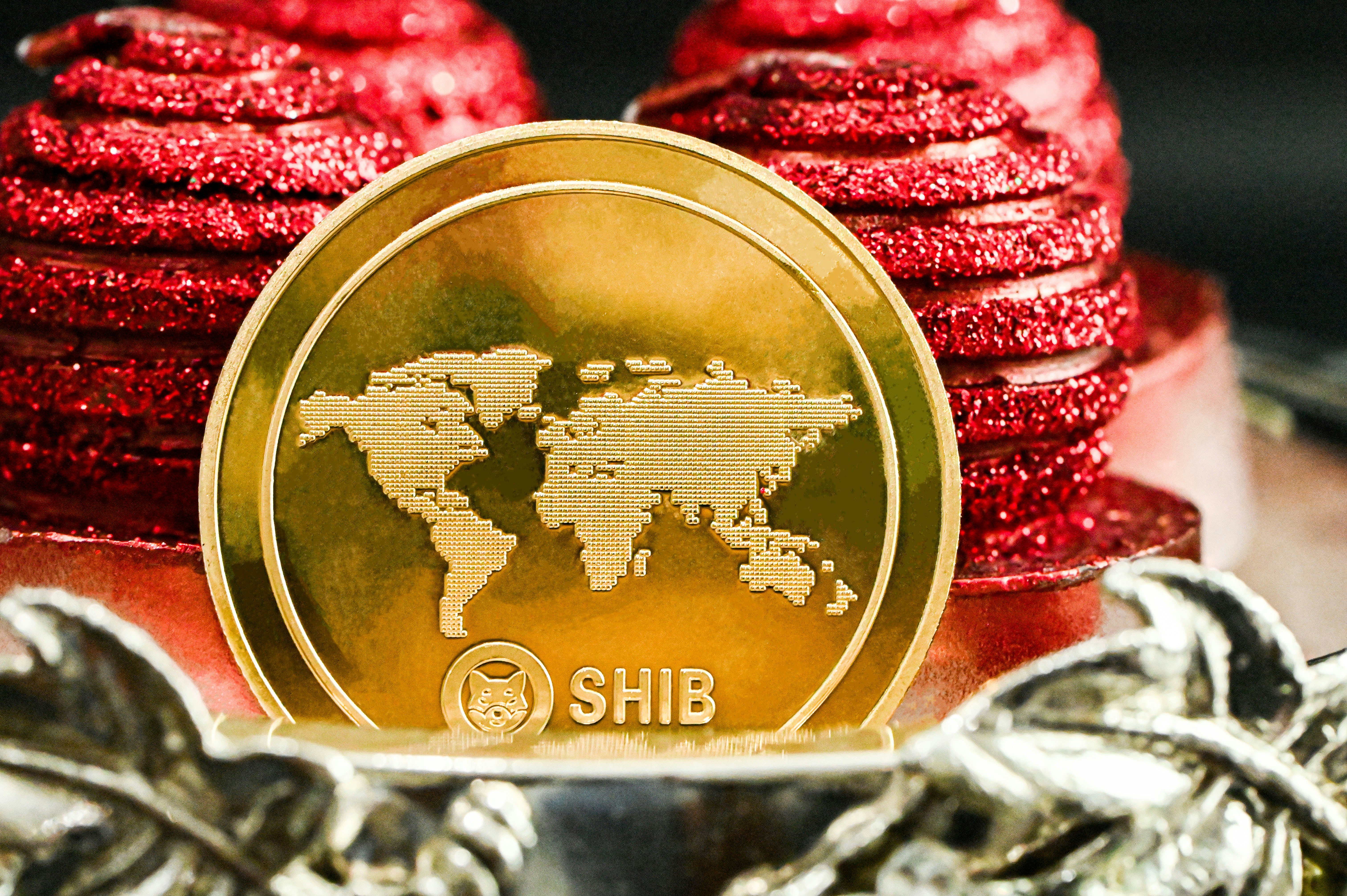A SHIB coin stands in front of the red balls