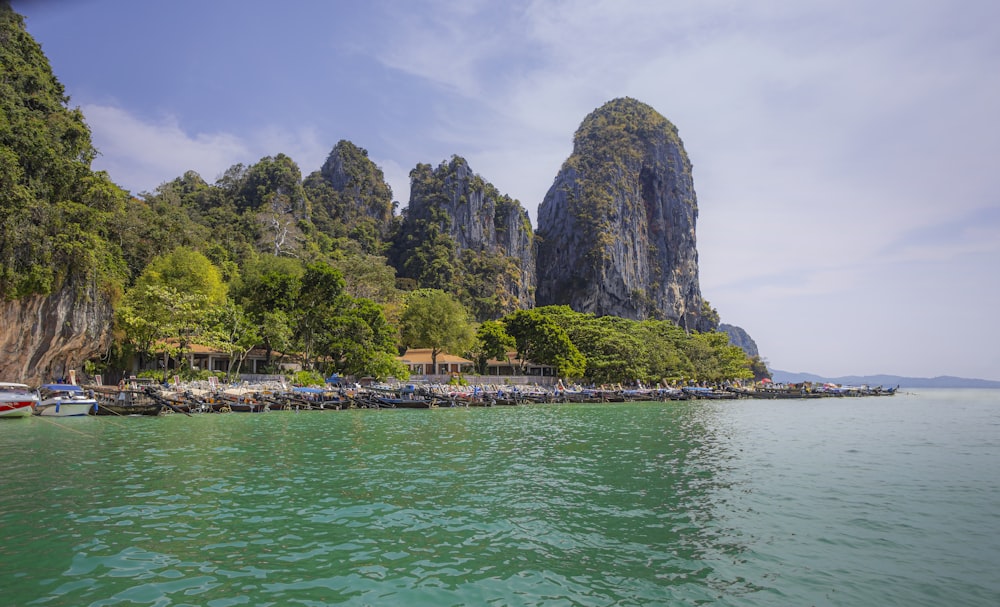 a body of water with boats and mountains in the background