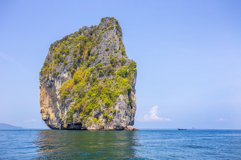 a large rock in the middle of the ocean