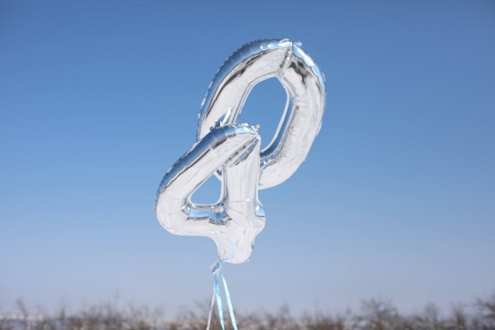 a balloon shaped like a number four hanging from a string