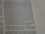 A close-up view of an open book page with printed text in English. The focus is on a particular section of text on the left, while the right side displays blank lines for note-taking.